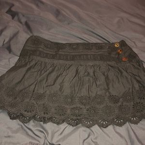 Grey designed skirt with brown buttons on side